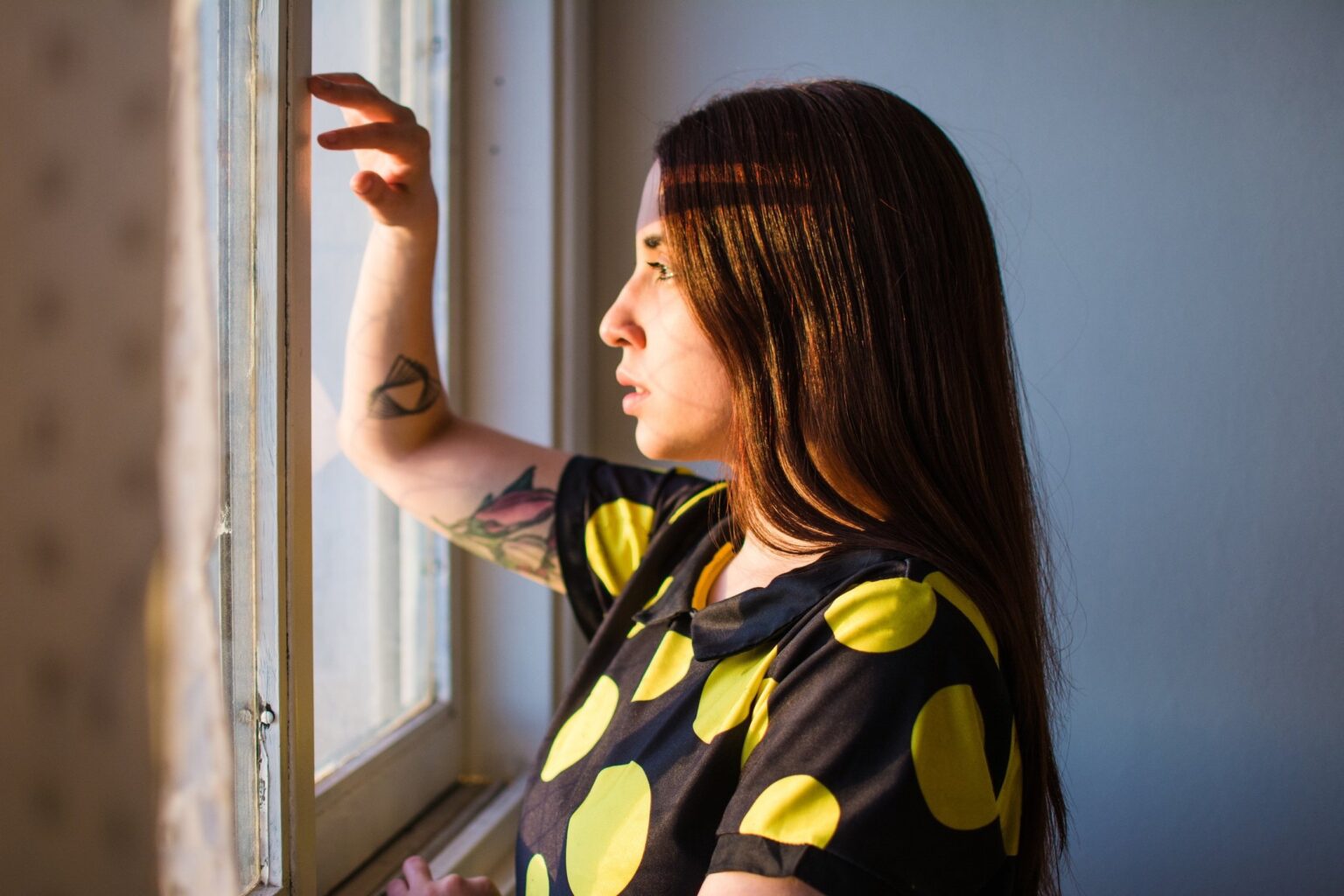 Woman looking out window in recovery